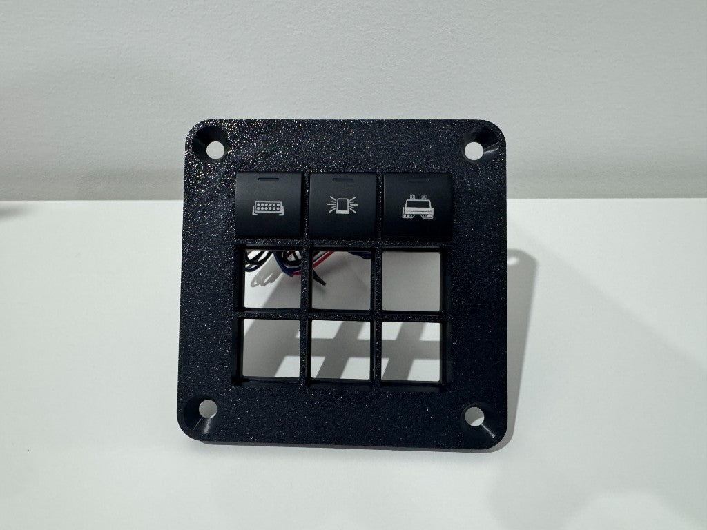 SINEWERX Toyota 3x3 switch panel fitted with 22mm square switches — front view showing 3 illuminated accessory switches installed in top row