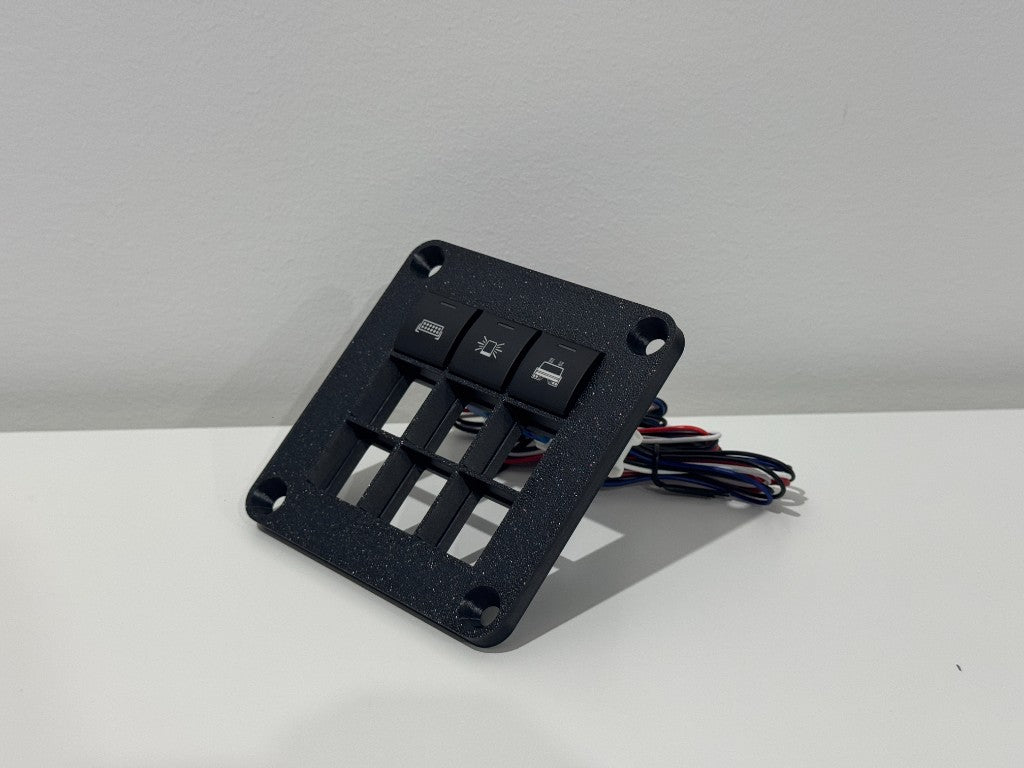 SINEWERX Toyota 22mm switch panel 3x3 — angled view with 3 switches wired up, showing rear wiring harness for 4WD accessory switch install
